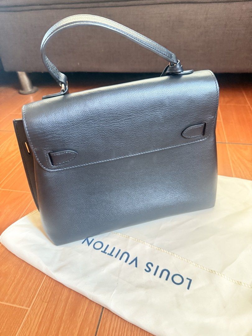 Louis Vuitton City Steamer Handbag (Category: Luxury Bags & Wallets) located in Taguig. Submitted by ara0813 (Listing ID 1437928952, Image 2). Description: - Authentic Louis Vuitton lockme ever BB handbag - Elegant dark color - Features a top handle - Secure flap closure with metal LV logo - Includes a detachable tag - Comes with a dust bag - Crafted from leather.