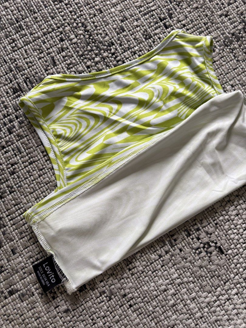 Lovito Green Swirl Crop Top (Category: Sleeveless) located in Binan City. Submitted by morticias_vault (Listing ID 1437778847, Image 2). Description: - Lovito crop top - Green and white swirl pattern - Round neckline - Sleeveless - Cropped style - Lightweight fabric - Perfect for warm weather - Pairs well with high-waisted bottoms.