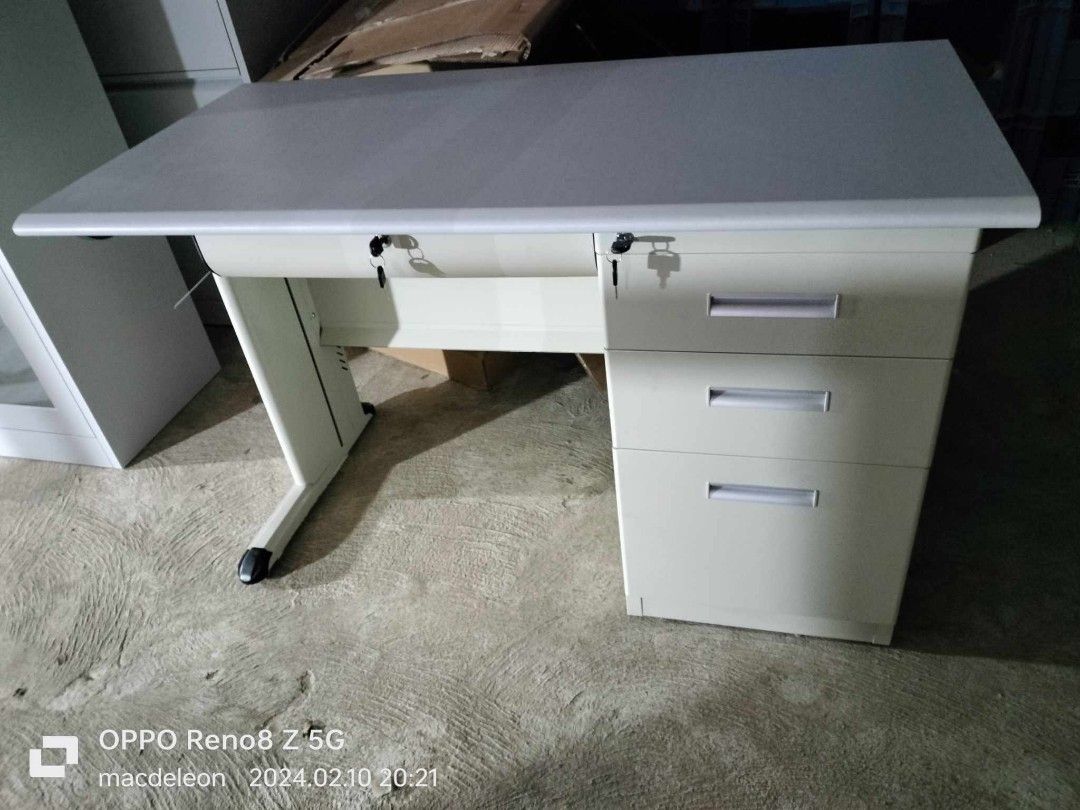 Metal Office Desk with Drawers (Category: Office Furniture & Fixtures) located in Manila. Submitted by jerrymieborda05 (Listing ID 1437921690, Image 2). Description: - Durable metal office desk - Light gray tabletop, cream frame - Three drawers - Small storage compartment - Lock included - Clean, minimalist design - Sturdy and functional.