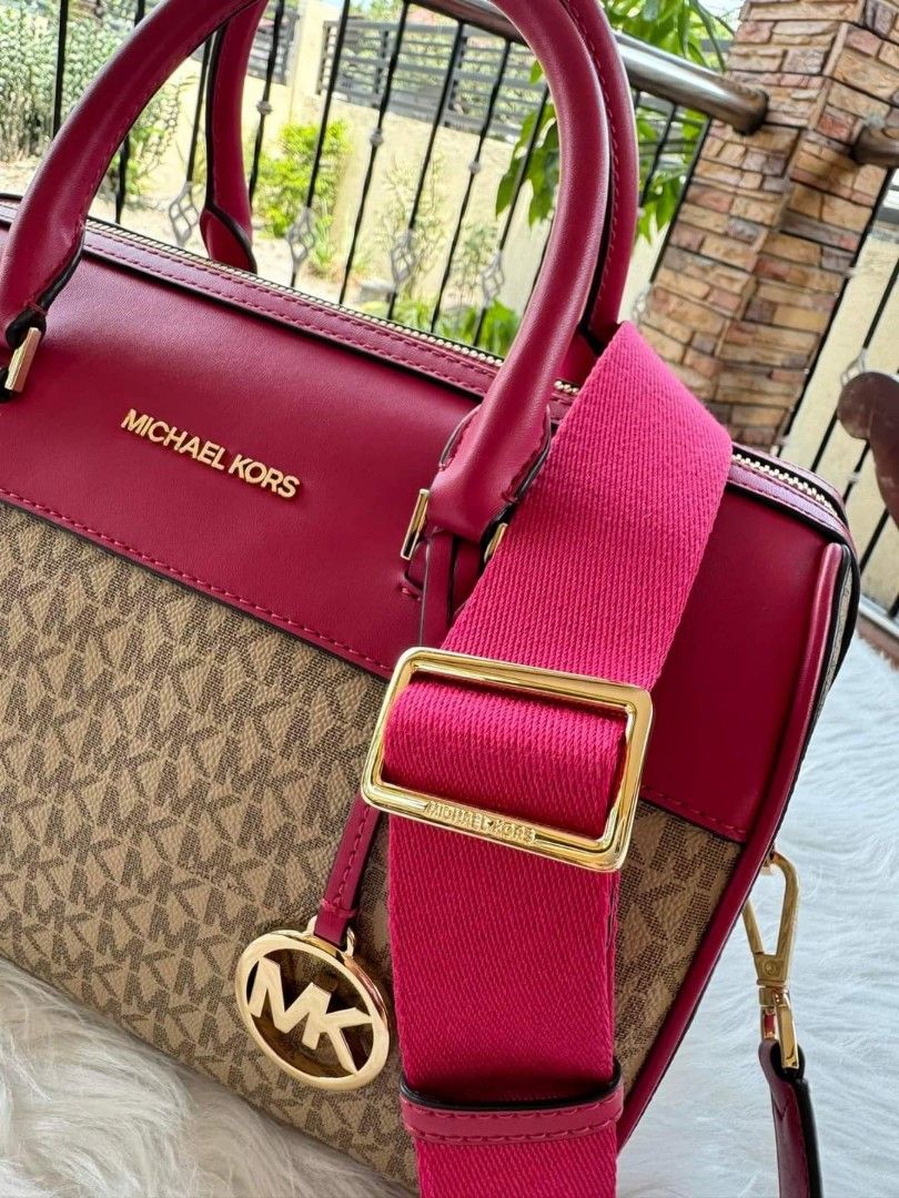 Michael Kors Duffle Bag (Category: Luxury Bags & Wallets) located in Guagua. Submitted by WearDTwinsCollections (Listing ID 1437780825, Image 2). Description: !! ON SALE !!! - On hand, reqdy to ship. - Michael Kors duffle bag - Color: Pink and Brown - Detachable shoulder strap - Gold-tone hardware - MK logo pattern - Top handle - Zip closure.