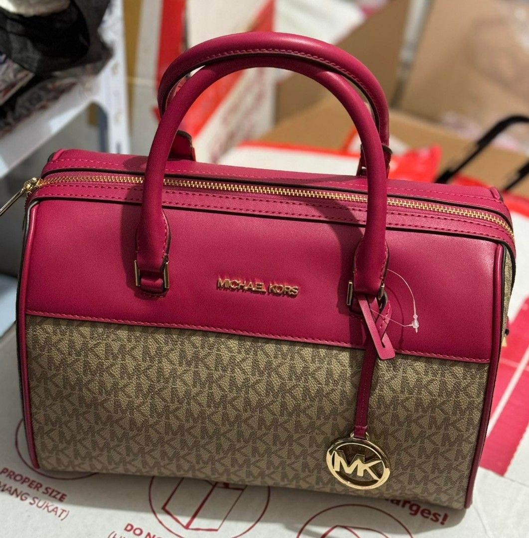 Michael Kors Duffle Bag (Category: Luxury Bags & Wallets) located in Guagua. Submitted by WearDTwinsCollections (Listing ID 1437780825, Image 3). Description: !! ON SALE !!! - On hand, reqdy to ship. - Michael Kors duffle bag - Color: Pink and Brown - Detachable shoulder strap - Gold-tone hardware - MK logo pattern - Top handle - Zip closure.