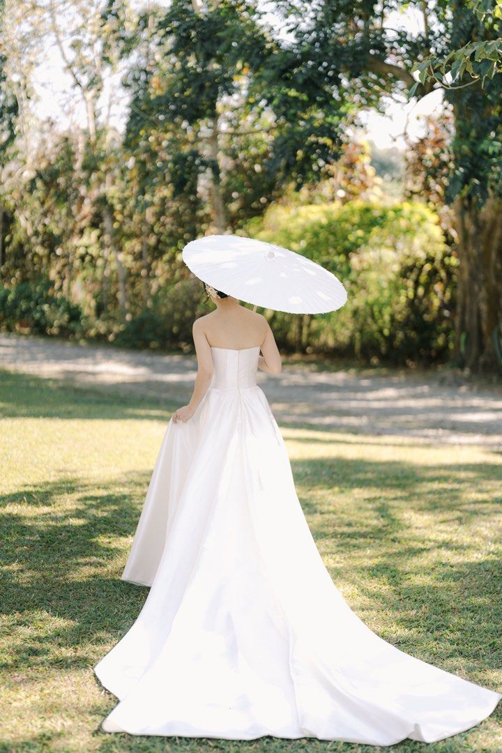 Minimalist Mikado Wedding Gown (Category: Evening dresses & gowns) located in Paranaque City. Submitted by meow_1222 (Listing ID 1437928956, Image 1). Description: Minimalist mikado wedding gown Worn last February 26, 2026 🌸 In excellent condition 🌸 Overlap skirt, with pockets 🌸 Measurements: 31 in bust, 25 in waist, 56 in Gown FL (bride in pic is 5 flat wearing 3.9 in heels) 🌸 Professionally dry cleaned, no more box/receipt (from Disenyo Pan