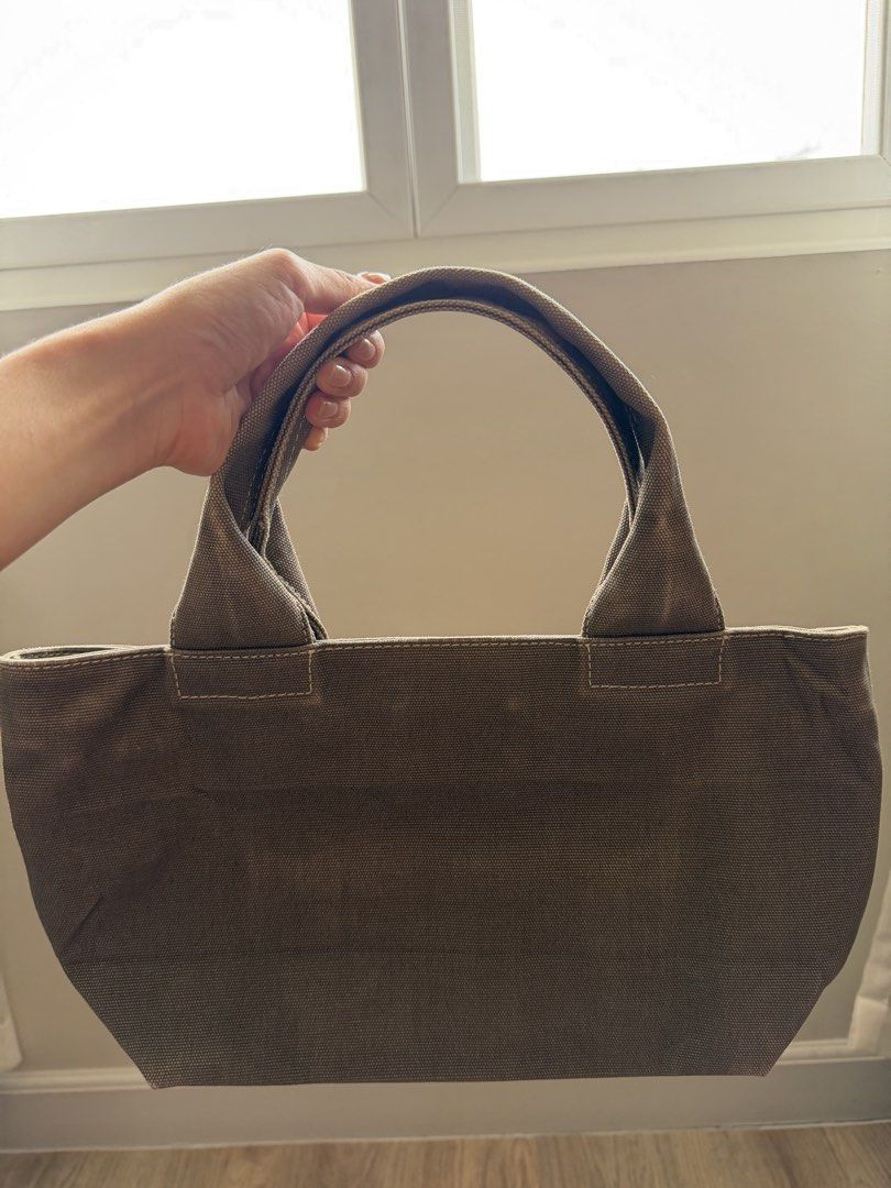 MJ Small Tote Bag (Category: Luxury Bags & Wallets) located in San Fernando. Submitted by somethingniceph (Listing ID 1437784777, Image 2). Description: - Small to medium sized tote bag - Canvas exterior - Zip closure - Gold-toned hardware - Multiple interior compartments.