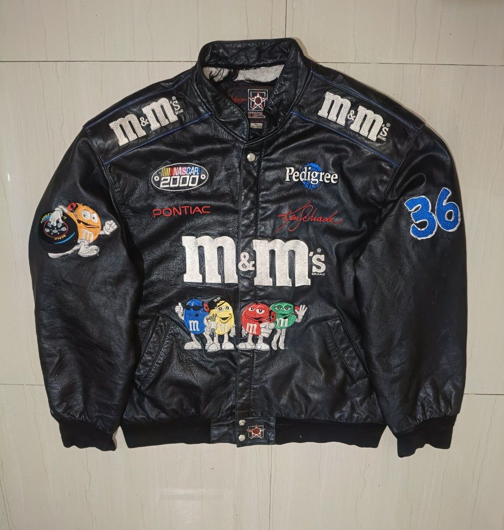 M&M's NASCAR Racing Jacket (Category: Coats, Jackets and Outerwear) located in Siniloan. Submitted by visionsupplyclothingco (Listing ID 1437778549, Image 1). Description: - Black jacket with M&M's and NASCAR branding - Features the number 36 on the sleeves - Includes various embroidered patches - Button-up front and collar - Made of a leather-like material - M&M's and Racing Team branding on the back - Perfect for fans and collectors! Vintage NA