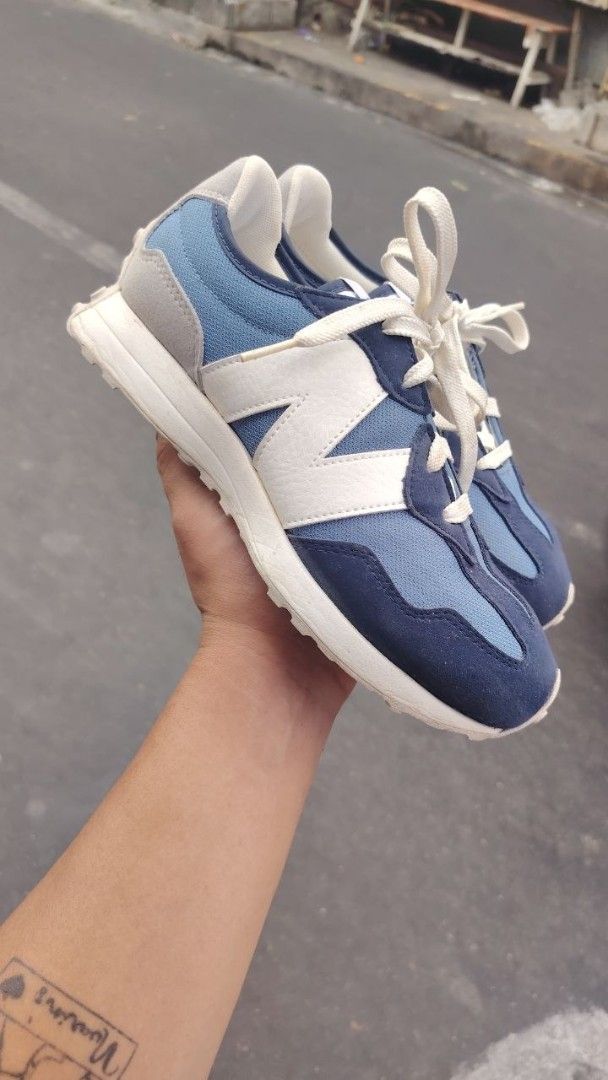 New Balance 327 Blue Sneakers (Category: Sneakers) located in Manila. Submitted by fheyyy_02 (Listing ID 1437879368, Image 2). Description: New Balance 327 sneakers in blue and white. Features the iconic New Balance logo on the side and tongue. The shoes have a blue and white color scheme with a suede and mesh upper. The soles are white with a textured pattern. The size is US 6.5, UK 4, EUR 37..