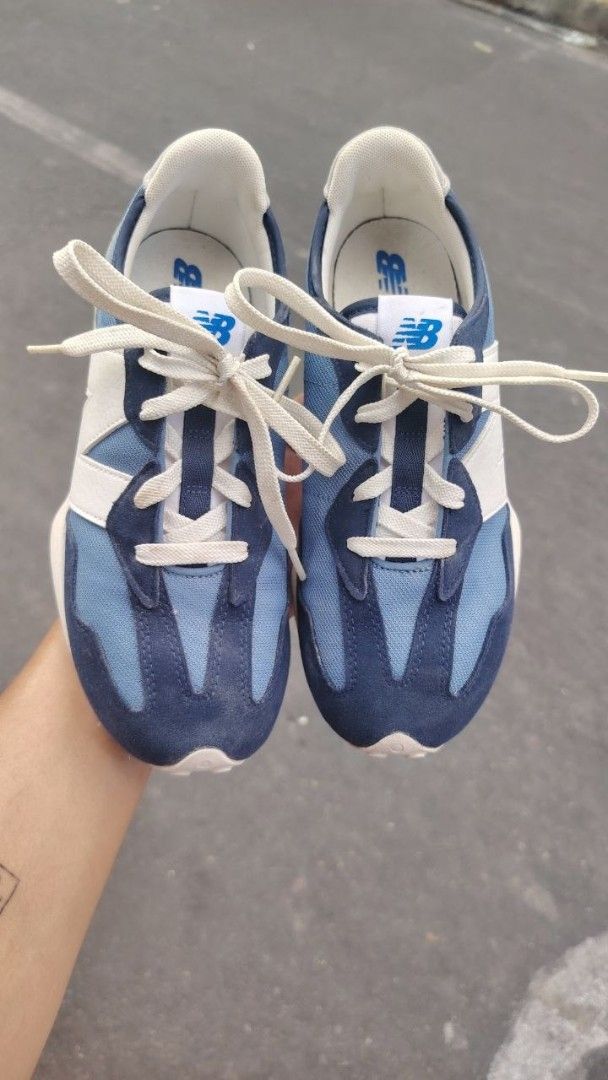 New Balance 327 Blue Sneakers (Category: Sneakers) located in Manila. Submitted by fheyyy_02 (Listing ID 1437879368, Image 1). Description: New Balance 327 sneakers in blue and white. Features the iconic New Balance logo on the side and tongue. The shoes have a blue and white color scheme with a suede and mesh upper. The soles are white with a textured pattern. The size is US 6.5, UK 4, EUR 37..