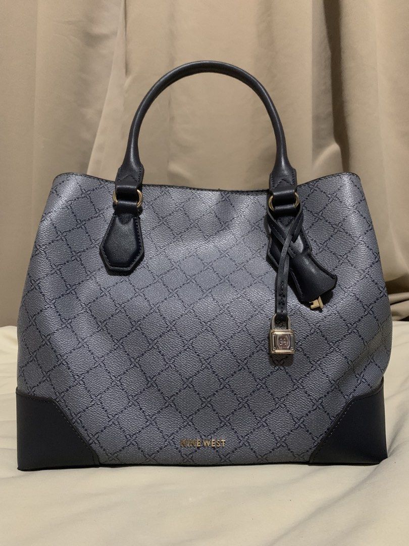 Nine West Handbag with Lock Detail (Category: Shoulder Bags) located in Makati City. Submitted by zzebraaa (Listing ID 1437781810, Image 2). Description: - Nine West handbag - Geometric pattern - Top handle and detachable shoulder strap - Lock detail - Zippered main compartment - Interior slip pocket and zippered pocket - Darker base and handle accents - Magnetic closure.