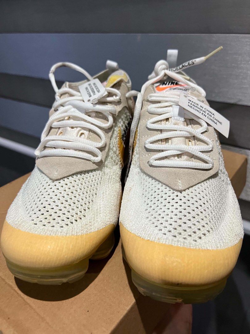 Off-White x Nike Air VaporMax (Category: Sneakers) located in Olongapo. Submitted by showhercloset (Listing ID 1437901627, Image 3). Description: - Off-White x Nike Air VaporMax sneakers - Features signature Off-White design: text graphics, zip tie - Includes original box - Colorway: White and Yellow -Condition: 4/10 (needs sole restoration) .