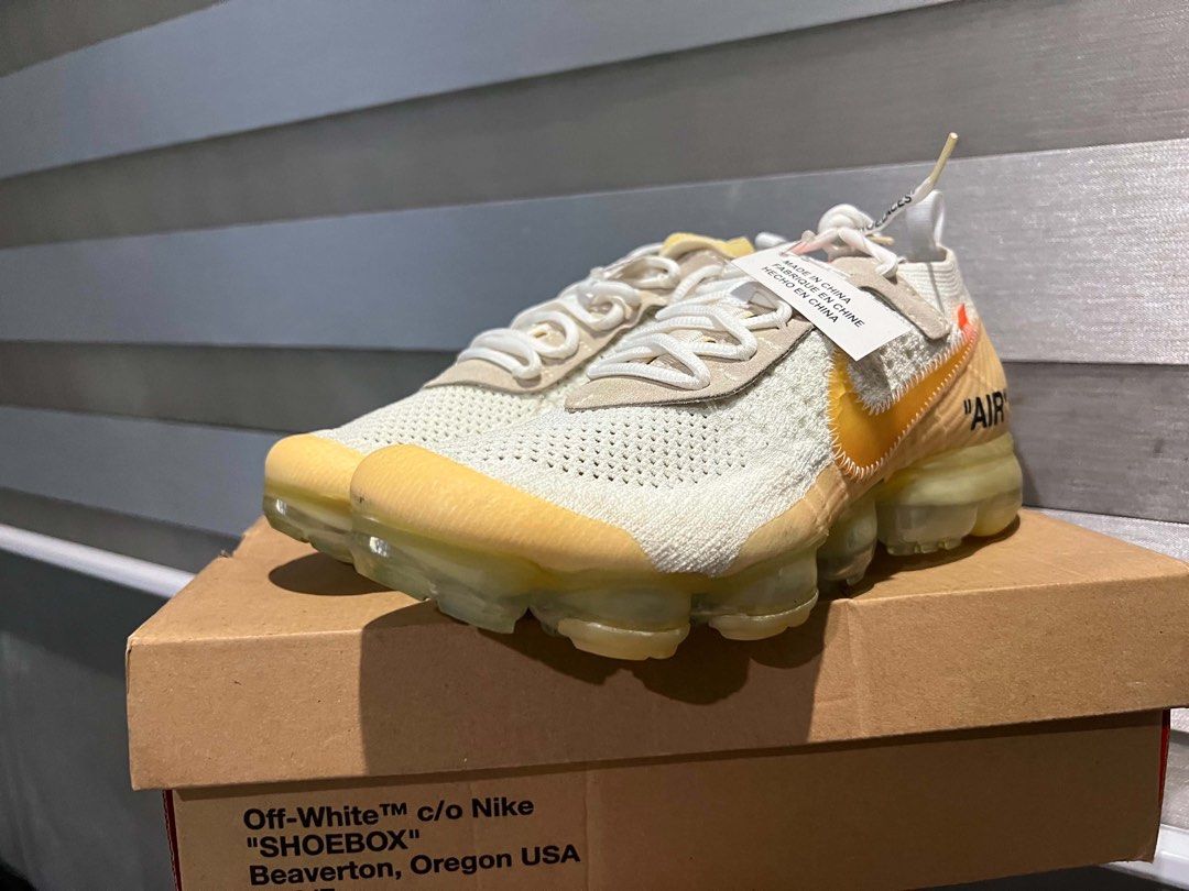 Off-White x Nike Air VaporMax (Category: Sneakers) located in Olongapo. Submitted by showhercloset (Listing ID 1437901627, Image 2). Description: - Off-White x Nike Air VaporMax sneakers - Features signature Off-White design: text graphics, zip tie - Includes original box - Colorway: White and Yellow -Condition: 4/10 (needs sole restoration) .