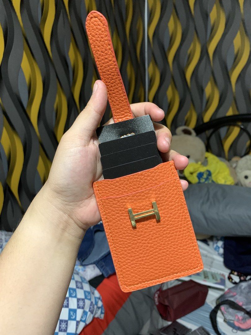 Orange Card Holder with Gold Accent (Category: Wallets & Card holders) located in Caloocan City. Submitted by kimpatchieee (Listing ID 1437768003, Image 3). Description: - Stylish orange card holder - Gold-colored accent - Secure strap closure - Multiple card slots - Textured material - Plain orange back.