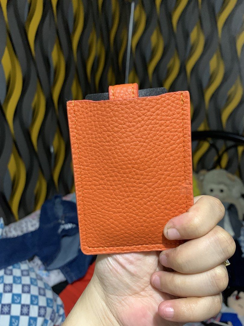 Orange Card Holder with Gold Accent (Category: Wallets & Card holders) located in Caloocan City. Submitted by kimpatchieee (Listing ID 1437768003, Image 2). Description: - Stylish orange card holder - Gold-colored accent - Secure strap closure - Multiple card slots - Textured material - Plain orange back.
