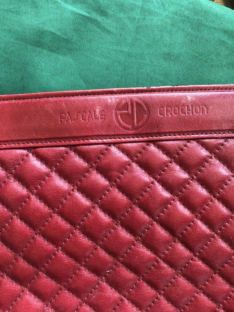 Pascale Crochon Red Quilted Shoulder Bag (Category: Shoulder Bags) located in Tabuk. Submitted by qurst (Listing ID 1437811872, Image 1). Description: - Pascale Crochon shoulder bag - Red color - Quilted front design - Smooth leather back - Features a long shoulder strap - Embossed brand name - Made of leather - Rectangular shape.