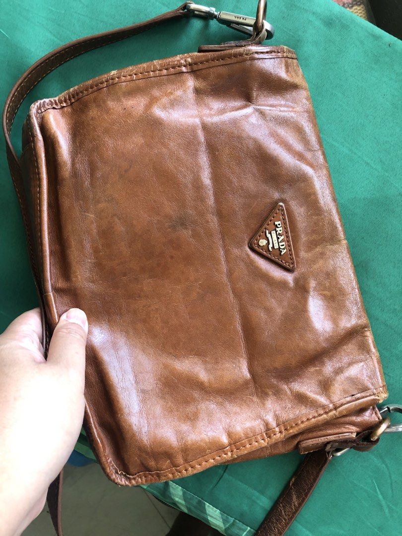Prada Brown Leather Shoulder Bag (Category: Luxury Bags & Wallets) located in Tabuk. Submitted by qurst (Listing ID 1437812175, Image 2). Description: - Authentic Prada shoulder bag - Brown leather - Flap closure with Prada logo - Detachable shoulder strap - Chain strap.