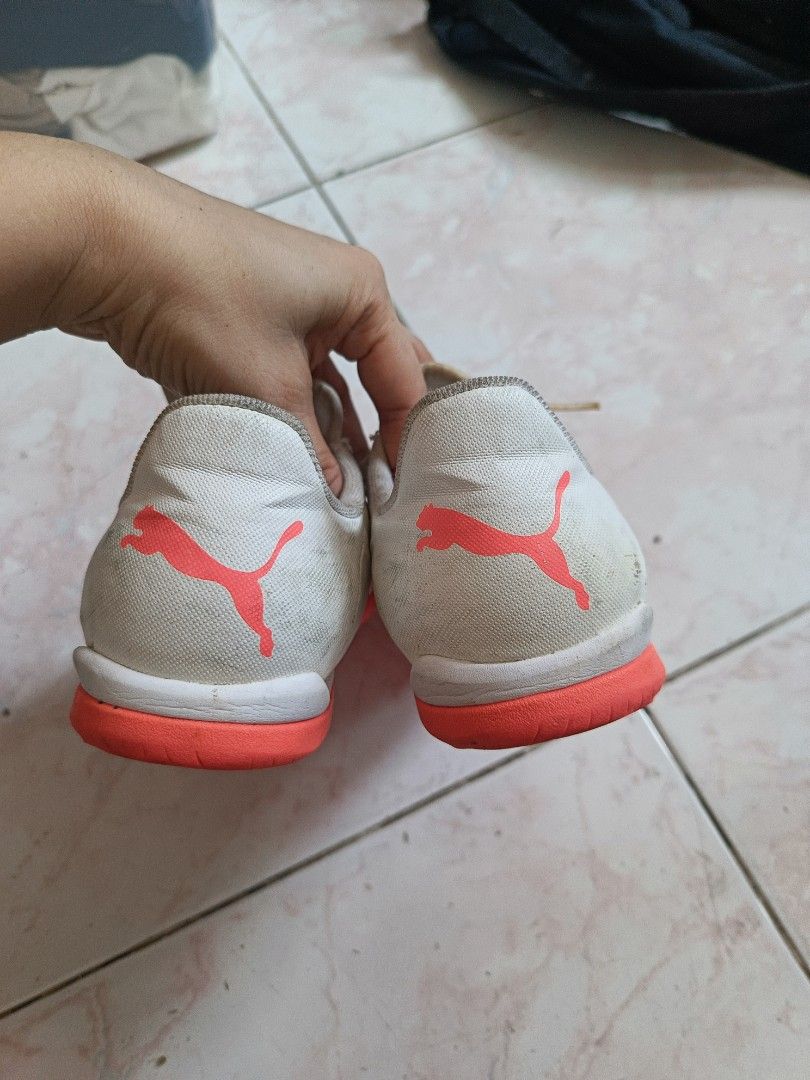 Puma Football Shoes (Category: Sneakers) located in Paombong. Submitted by eveiveneg09 (Listing ID 1437796534, Image 3). Description: - White upper with orange accents - Orange sole - Laced closure - Puma logo on side and heel - Signs of wear on soles.
