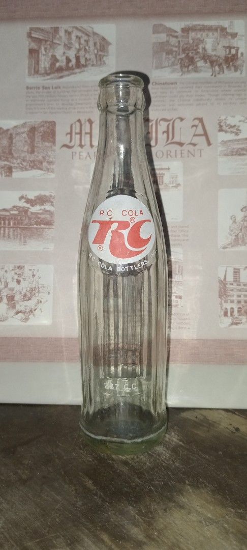 RC Cola Bottle (Category: Water Bottles & Tumblers) located in Manila. Submitted by iamrich110502 (Listing ID 1437838245, Image 1). Description: - Vintage RC Cola bottle - Features the RC Cola logo - Clear glass body - Green base - Classic bottle shape - Empty.