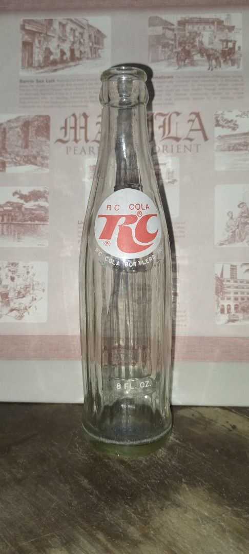 RC Cola Bottle (Category: Water Bottles & Tumblers) located in Manila. Submitted by iamrich110502 (Listing ID 1437838245, Image 2). Description: - Vintage RC Cola bottle - Features the RC Cola logo - Clear glass body - Green base - Classic bottle shape - Empty.