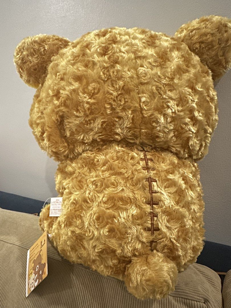 Rilakkuma 20th Anniversary Plush Toy (Category: Plushies & Soft Toys) located in Taguig. Submitted by beerackph (Listing ID 1437925537, Image 2). Description: - Rilakkuma 20th Anniversary Plush - Features a heart-shaped emblem - Unique textured fur - Golden-brown color - Includes original tags - Made in Vietnam.