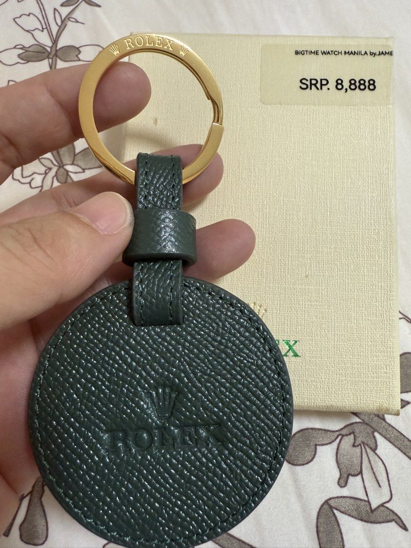 Rolex Key Chain (Category: Luxury Accessories) located in Quezon City. Submitted by rvrvrv8 (Listing ID 1437908222, Image 2). Description: - Genuine Rolex key chain - Green leather disc with Rolex logo - Gold-colored key ring - Includes original box from Bigtime Watch Manila by Jame - SRP: ₱8,888.