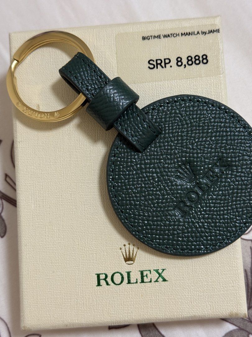 Rolex Key Chain (Category: Luxury Accessories) located in Quezon City. Submitted by rvrvrv8 (Listing ID 1437908222, Image 1). Description: - Genuine Rolex key chain - Green leather disc with Rolex logo - Gold-colored key ring - Includes original box from Bigtime Watch Manila by Jame - SRP: ₱8,888.