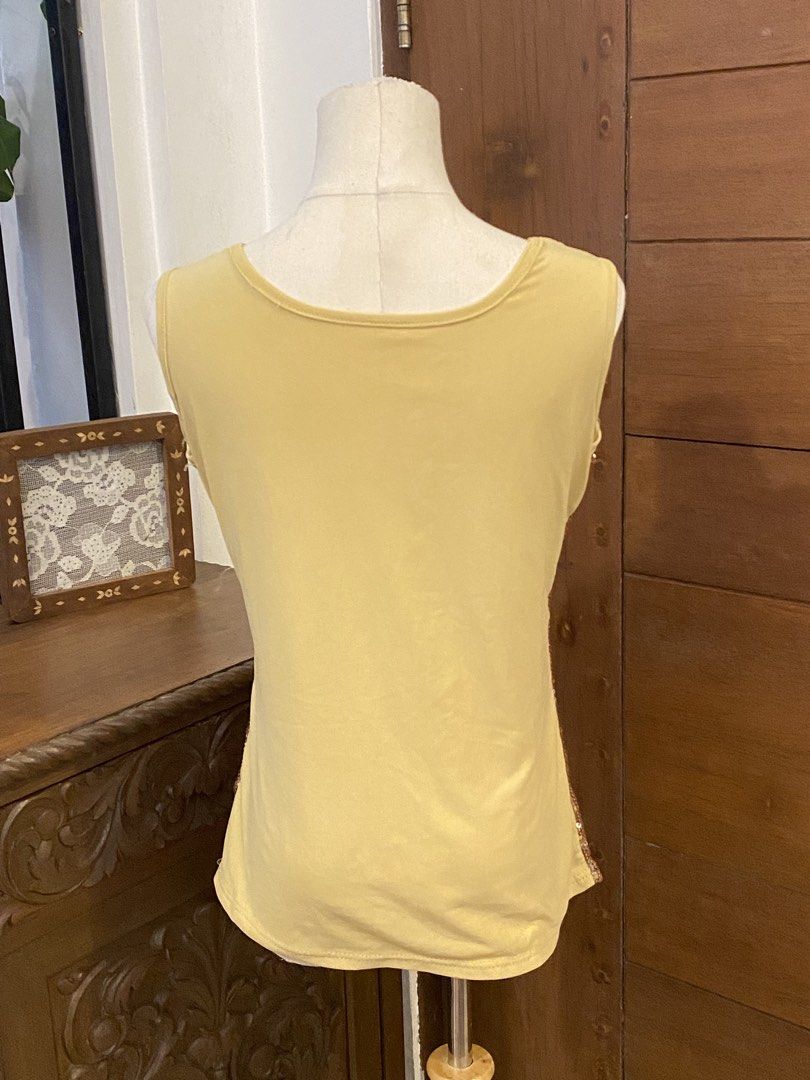 Sequin Embellished Tank Top Gold Large (Category: Sleeveless) located in Manila. Submitted by bels.finds (Listing ID 1437813798, Image 2). Description: - Sequin embellished tank top - Features a detailed design with yellow gold lace overlay on the front - Hannah Montana Vibes!!! - Scoop neckline.
