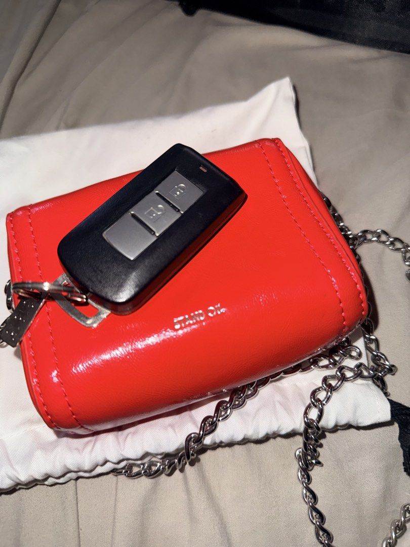 Stand Oil Red Chain Bag (Category: Luxury Bags & Wallets) located in Pasig City. Submitted by dindin25 (Listing ID 1437790748, Image 3). Description: - Stand Oil red chain bag - Glossy finish - Silver chain strap - Includes white drawstring dust bag - Stand Oil logo visible - Compact size, perfect for essentials.