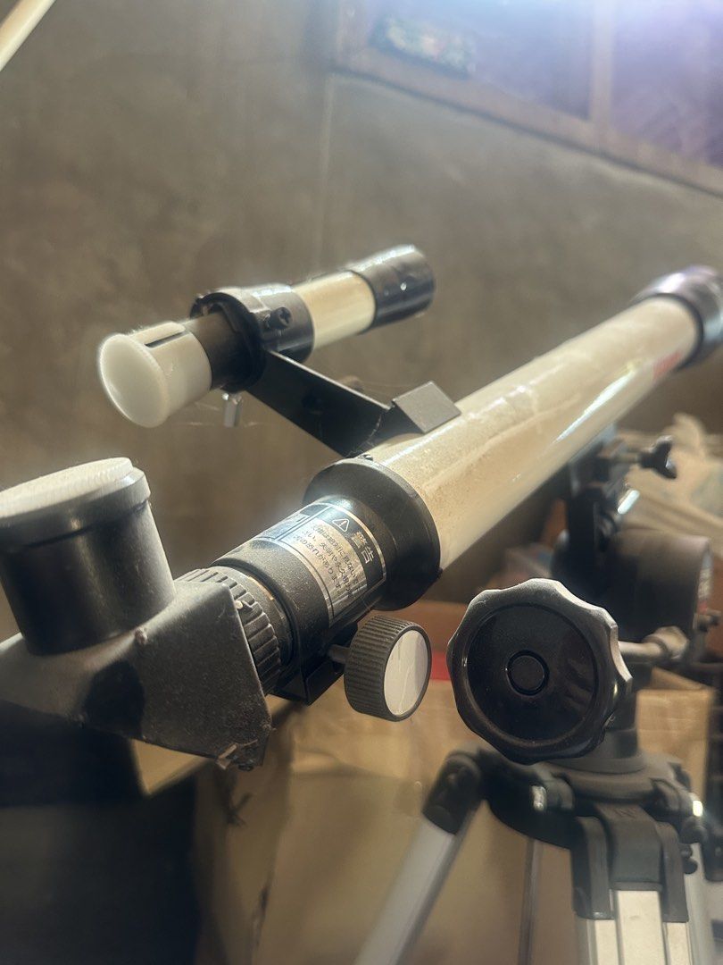 Telescope with Tripod (Category: Tripods & Monopods) located in Manila. Submitted by rizzetsu (Listing ID 1437796358, Image 1). Description: - Telescope with tripod and secondary scope included. - Features adjustment knobs. - In good working condition. - Ideal for stargazing and observing distant objects. - Main tube color: Beige. Secondary scope color: Black and Beige..