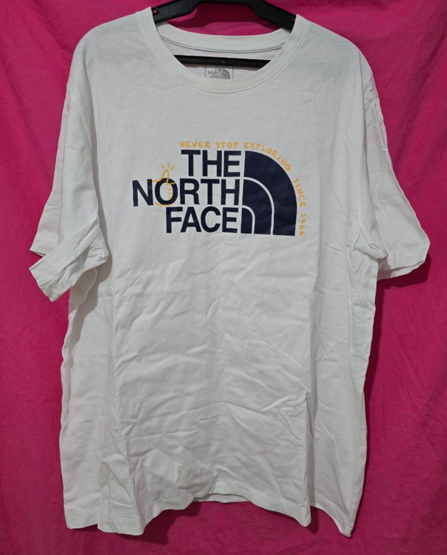 The North Face White T-shirt (Category: Tshirts & Polo Shirts ) located in Quezon City. Submitted by smallblackant (Listing ID 1437800110, Image 1). Description: - The North Face t-shirt - Color: White - Features a large logo on the front with "Never Stop Exploring Since 1966" - Small logo on the back - Size: US XL / Asia XXL - Made in China 23.5 X 30 sf c/o buyer.
