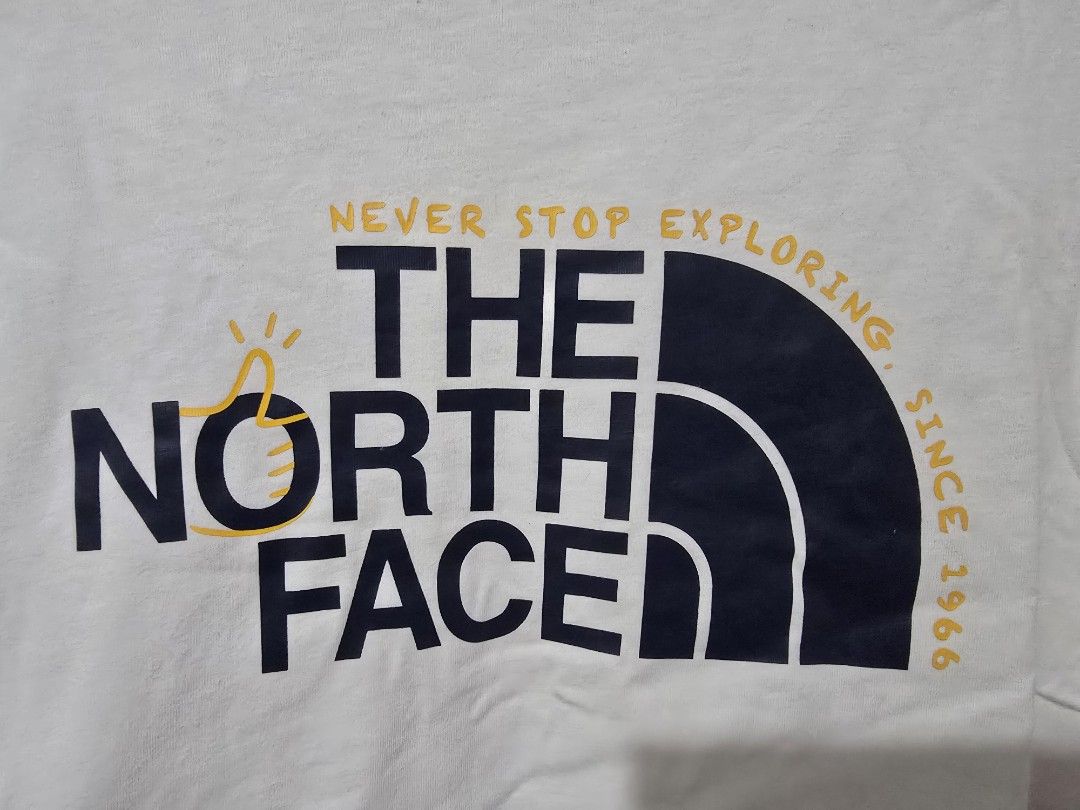 The North Face White T-shirt (Category: Tshirts & Polo Shirts ) located in Quezon City. Submitted by smallblackant (Listing ID 1437800110, Image 2). Description: - The North Face t-shirt - Color: White - Features a large logo on the front with "Never Stop Exploring Since 1966" - Small logo on the back - Size: US XL / Asia XXL - Made in China 23.5 X 30 sf c/o buyer.