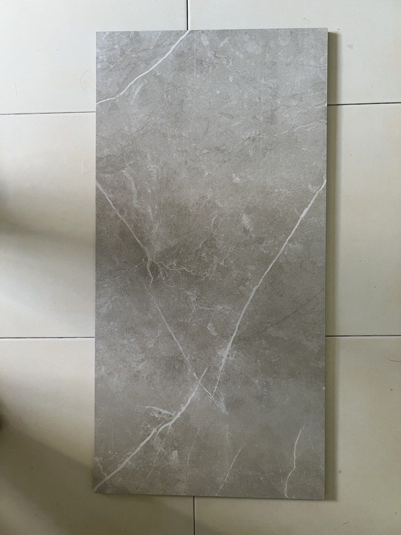 Tiles (Category: Home Improvement Tools & Accessories) located in Singapore. Submitted by gno123 (Listing ID 1437282721, Image 3). Description: Tiles of dimension 60cm by 3cm. $8 per piece. AAA grade. 1) White - 4 pieces 2) White with grey waves pattern - 4 pieces 3) Khaki - 16 pieces Self collection at postal code 520298 (Tampines St 22)..