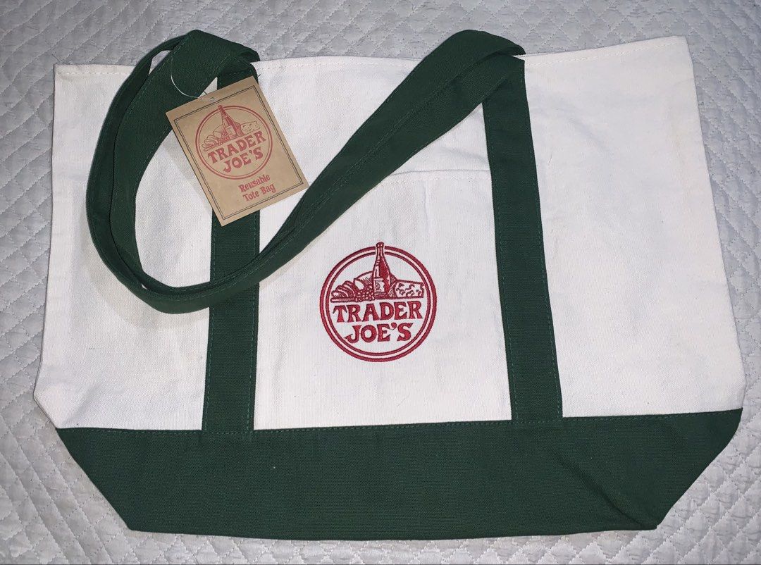Tote Bag (Category: Tote Bags) located in Manila. Submitted by ads29 (Listing ID 1437781908, Image 2). Description: - Available 9pcs - Trader Joe's tote bag - Galing America - White body with green accents and handles - Features the Trader Joe's logo - Includes tag - Reusable - Stylish and practical.