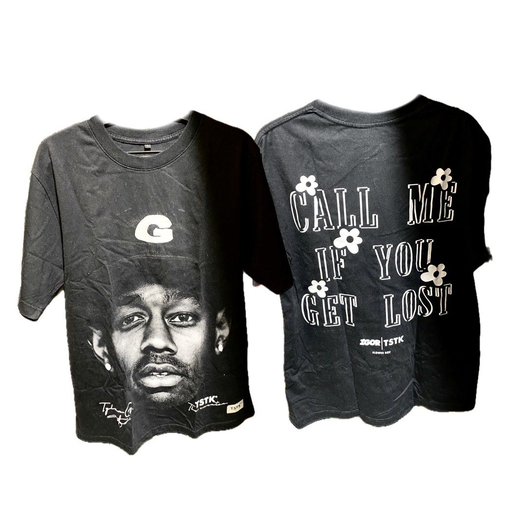 TSTK Tyler The Creator Graphic Tee in LARGE (Category: Tshirts & Polo Shirts ) located in Manila. Submitted by faerikhae (Listing ID 1437730952, Image 2). Description: - Black T-shirt featuring Tyler, The Creator graphic. - Back design includes the phrase "CALL ME IF YOU GET LOST". - Brand: TSTK. - Design includes floral accents. - Features the TSTK logo. -has minor flaws like loose threads but barely noticeable. .