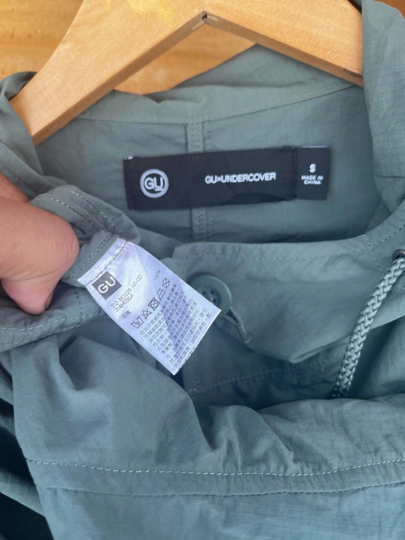 Undercover x Gu 2-Way Oversized Mod Coat Olive (Category: Coats, Jackets and Outerwear) located in Maasin. Submitted by trippythirftyyy (Listing ID 1437799184, Image 3). Description: - Olive green GU x Undercover hooded jacket - Size: S - Features: Drawstring hood, multiple pockets, button-up closure - Details: Chest and bottom patches with text -complete tags -missing lower part , hoodie only available .