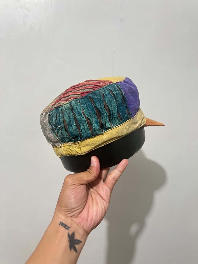 Vintage Patchwork hippie cap (Category: Caps & Hats) located in Naga. Submitted by retro_rackph (Listing ID 1437934317, Image 2). Description: - Vintage patchwork cap - Features a flat brim - Structured design - Vibrant mix of colors: green, purple, yellow, and orange - Made from various fabric pieces - Distinctive and eye-catching style.