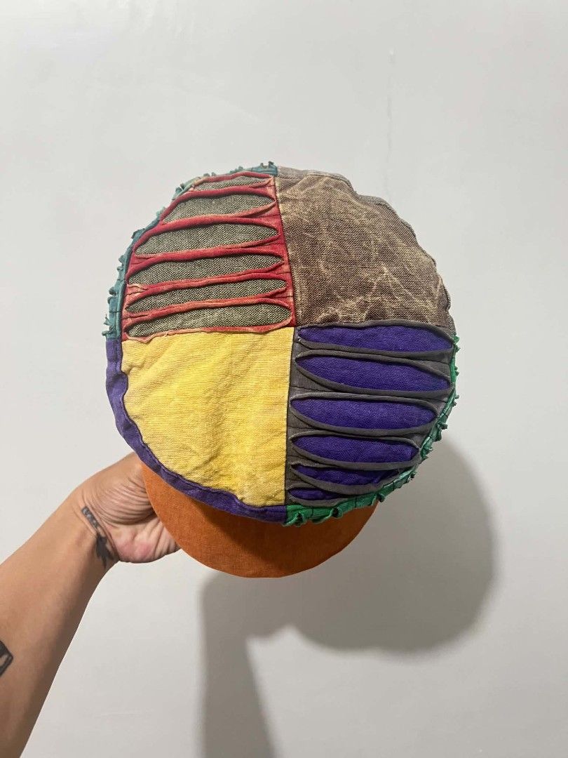 Vintage Patchwork hippie cap (Category: Caps & Hats) located in Naga. Submitted by retro_rackph (Listing ID 1437934317, Image 3). Description: - Vintage patchwork cap - Features a flat brim - Structured design - Vibrant mix of colors: green, purple, yellow, and orange - Made from various fabric pieces - Distinctive and eye-catching style.