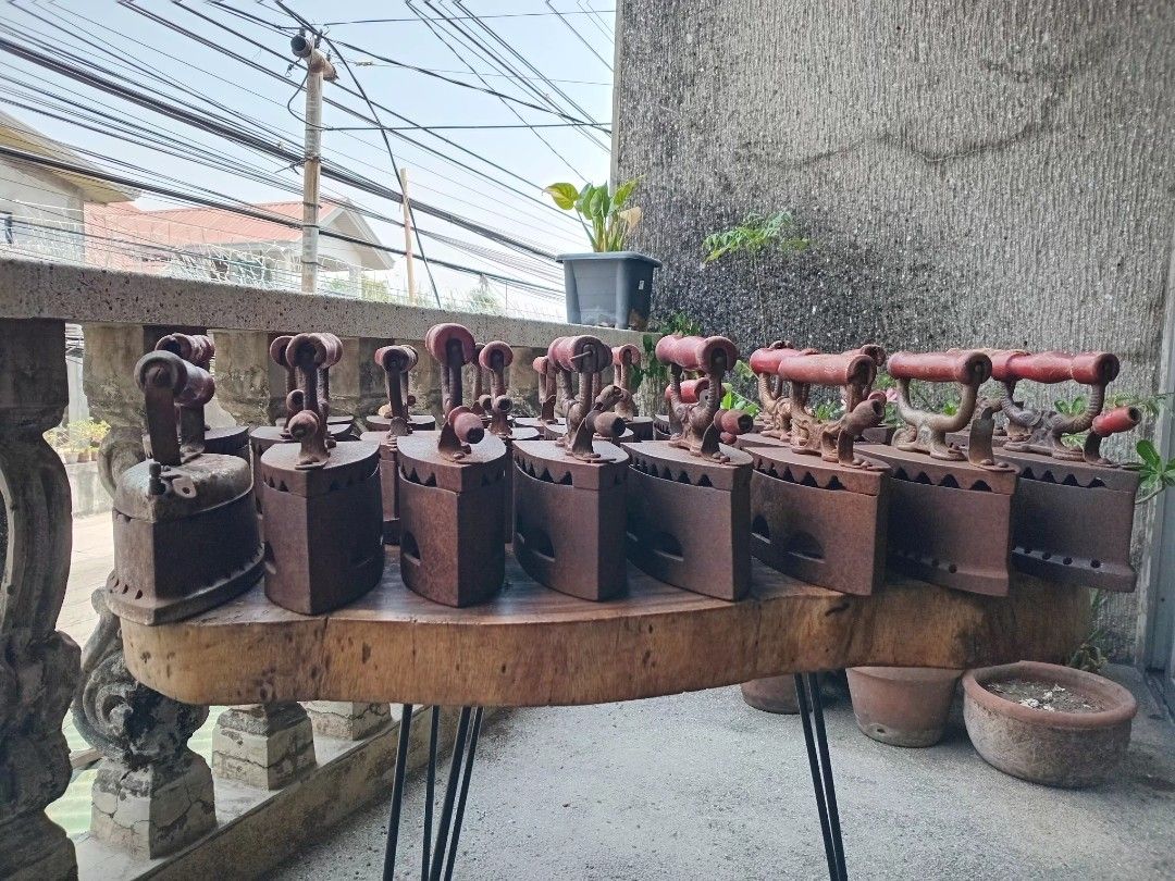 Vintage Philippine charcoal flat irons, "plantsa de uling" (Category: Irons & Steamers) located in San Fernando. Submitted by josephtanjuaquio (Listing ID 1437793712, Image 2). Description: Vintage Philippine charcoal flat irons, "plantsa de uling" Usage: These irons were heated by filling the hollow cast-iron body with hot charcoal. Design: They typically feature a cast-iron body with vent holes along the sides and a wooden handle for insulation