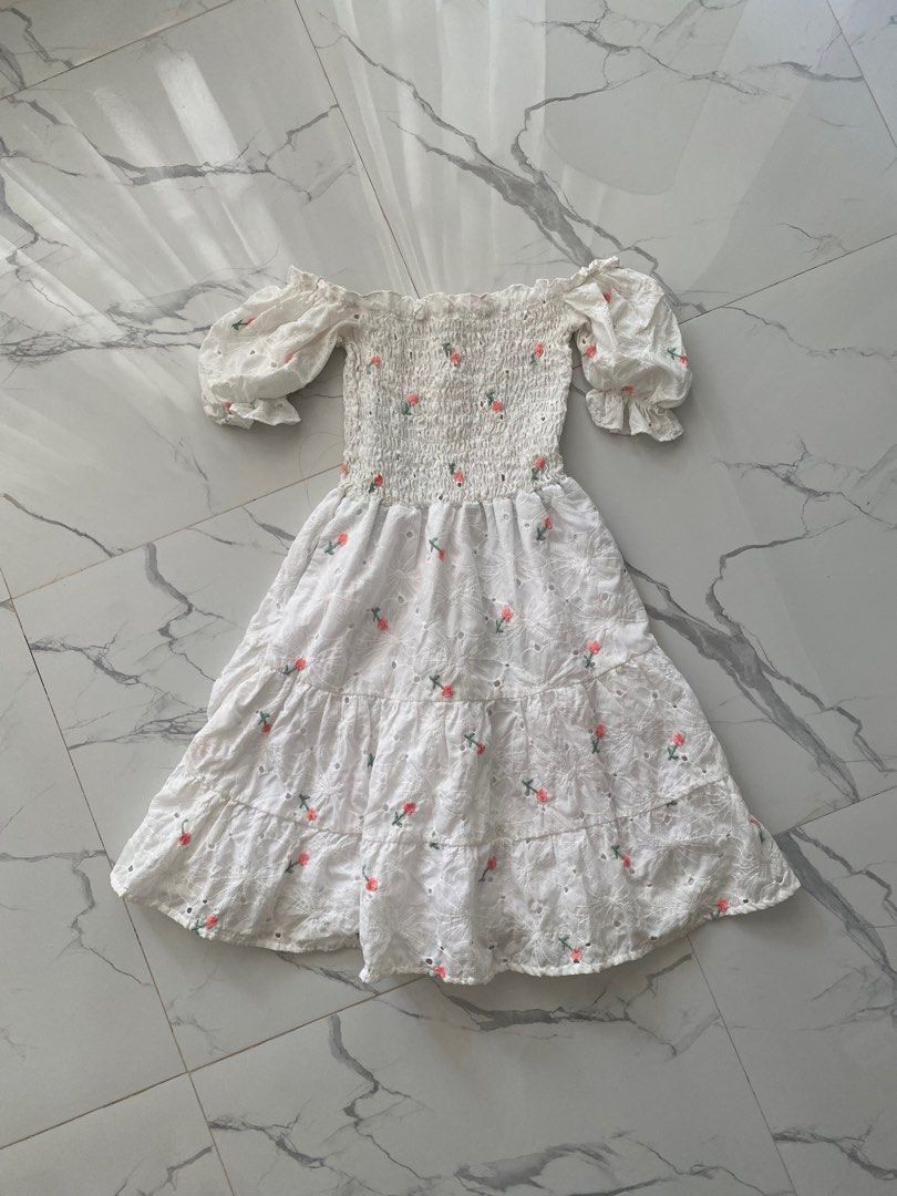 White Embroidered Eyelet Cottagecore Dress (Category: Dresses) located in Santa Rosa. Submitted by 014cauliflower (Listing ID 1437793603, Image 2). Description: - White dress with pink flower embroidery - Features a smocked bodice and eyelet fabric - Puff sleeves - Tiered skirt design - cottagecore.