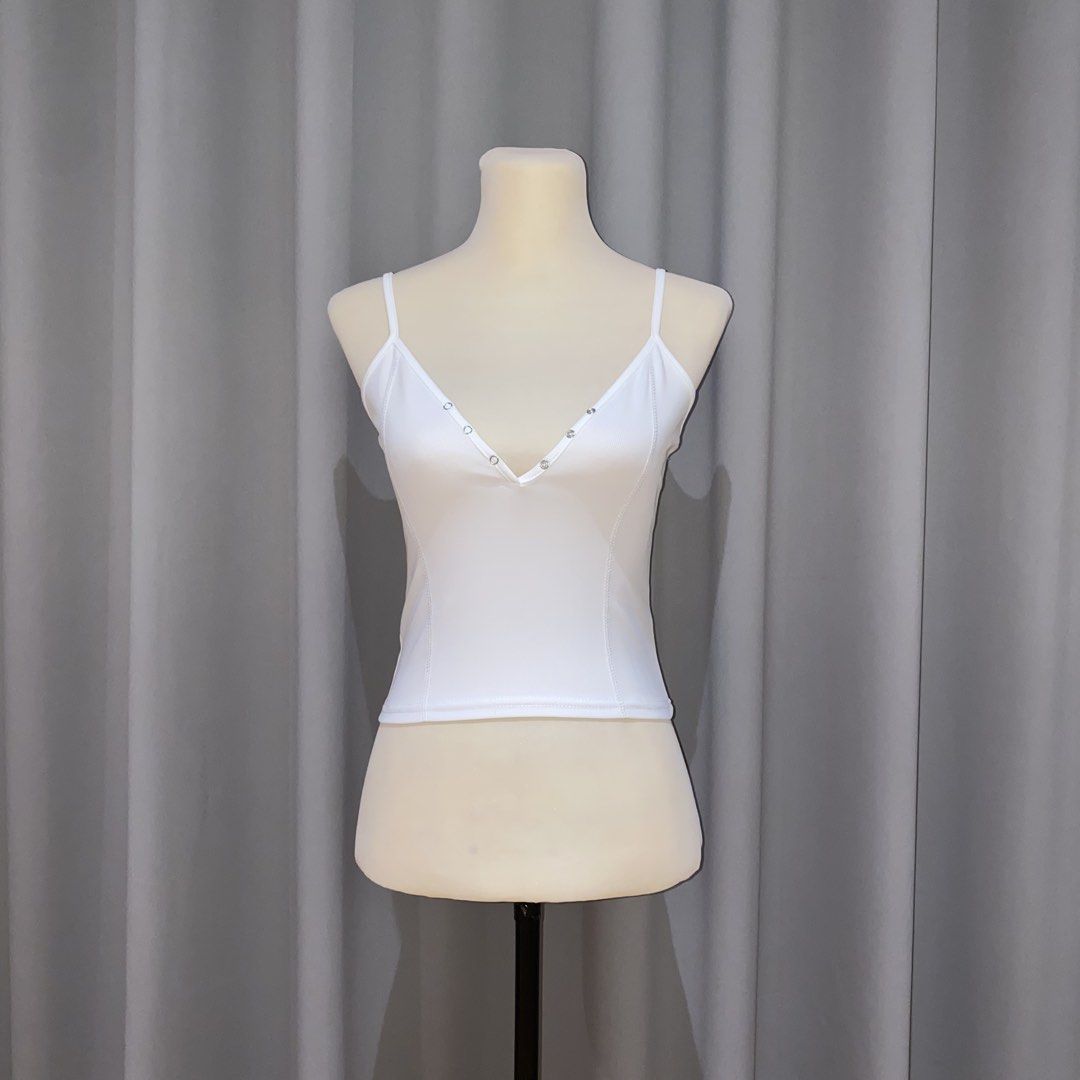 white cropped cami top (Category: Sleeveless) located in Muntinlupa City. Submitted by declutterwithkk (Listing ID 1437930057, Image 1). Description: - white cropped cami top - front button for adjustable neckline.