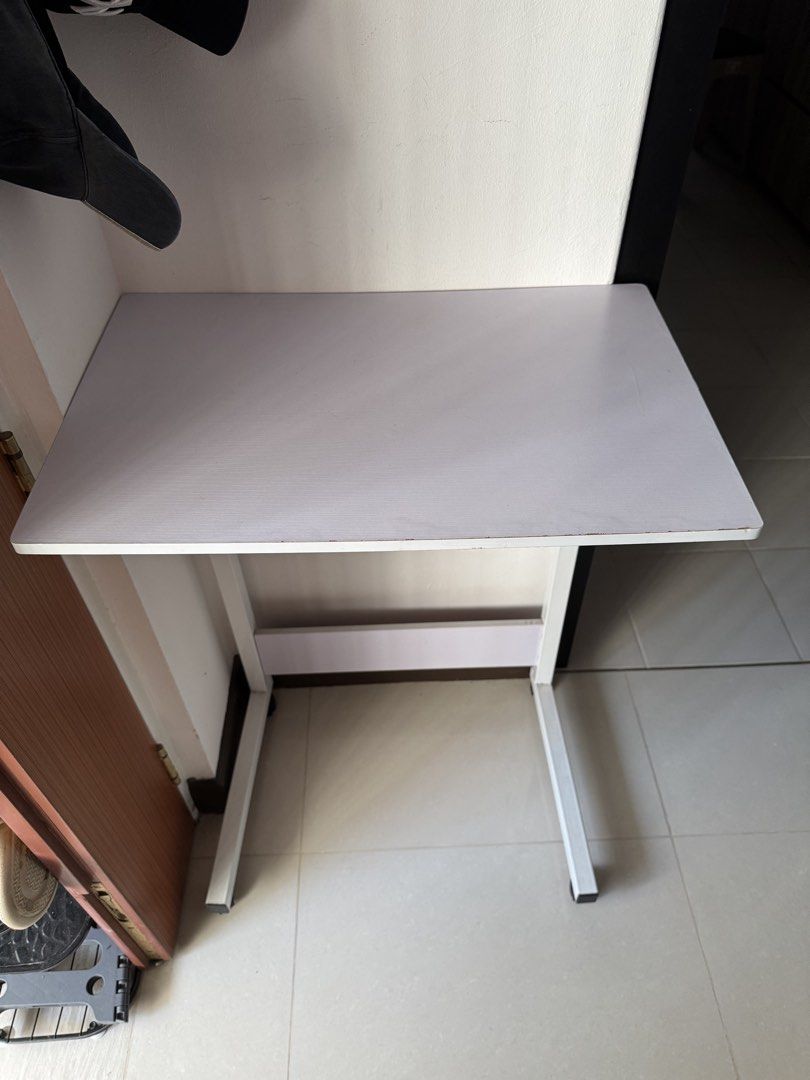White Study Table (Category: Tables & Sets) located in Singapore. Submitted by salomeching (Listing ID 1437764161, Image 1). Description: - White study table - Suitable for small spaces - White tabletop with wood grain pattern - White metal legs - Minor wear and tear on edges.