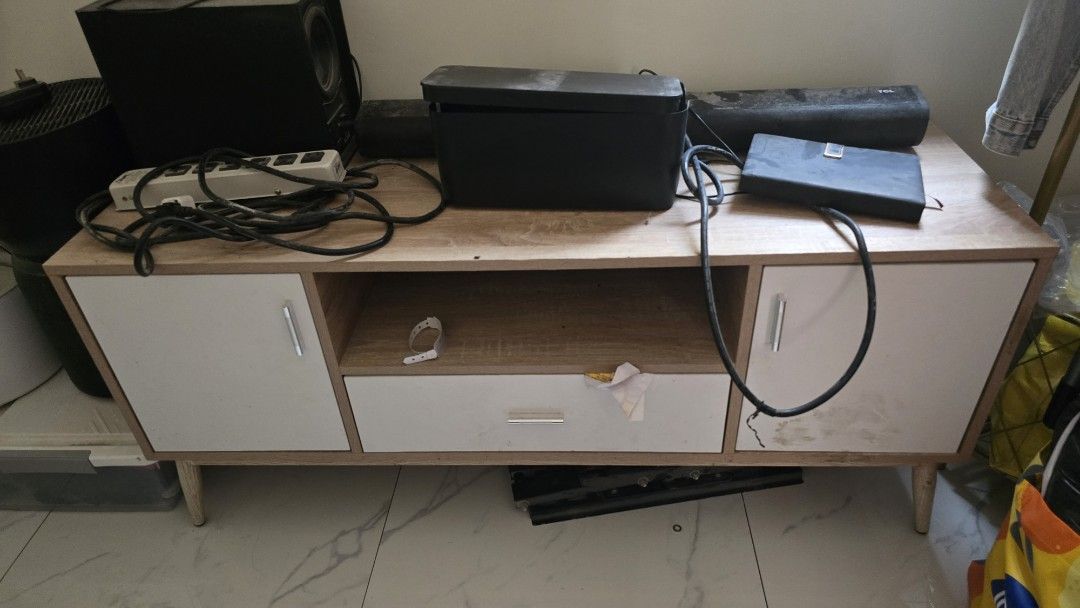 Wooden TV Cabinet with Storage (Category: Shelves, Cabinets & Racks) located in Manila. Submitted by imandreana33270 (Listing ID 1437907773, Image 2). Description: ✨ GARAGE SALE • PRE-LOVED ITEMS ✨ - Modern wooden TV cabinet - Two side cabinets for storage - Central open shelf for media players - One drawer for additional storage - Stylish light wood finish - White cabinet doors and drawer front - Supported by angled wooden legs - Perfect for you