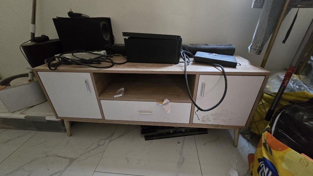 Wooden TV Cabinet with Storage (Category: Shelves, Cabinets & Racks) located in Manila. Submitted by imandreana33270 (Listing ID 1437907773, Image 1). Description: ✨ GARAGE SALE • PRE-LOVED ITEMS ✨ - Modern wooden TV cabinet - Two side cabinets for storage - Central open shelf for media players - One drawer for additional storage - Stylish light wood finish - White cabinet doors and drawer front - Supported by angled wooden legs - Perfect for you