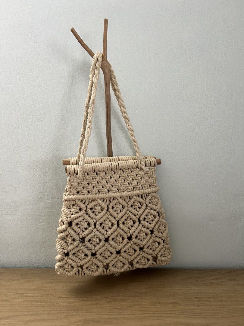 Zara Basic Macrame Handbag (Category: Shoulder Bags) located in Singapore. Submitted by ikml2015 (Listing ID 1437816115, Image 2). Description: Beautiful Zara Basic macrame handbag. Features a unique woven design with a tassel detail. The bag has sturdy handles and a wooden bar at the top. Perfect for adding a bohemian touch to any outfit..