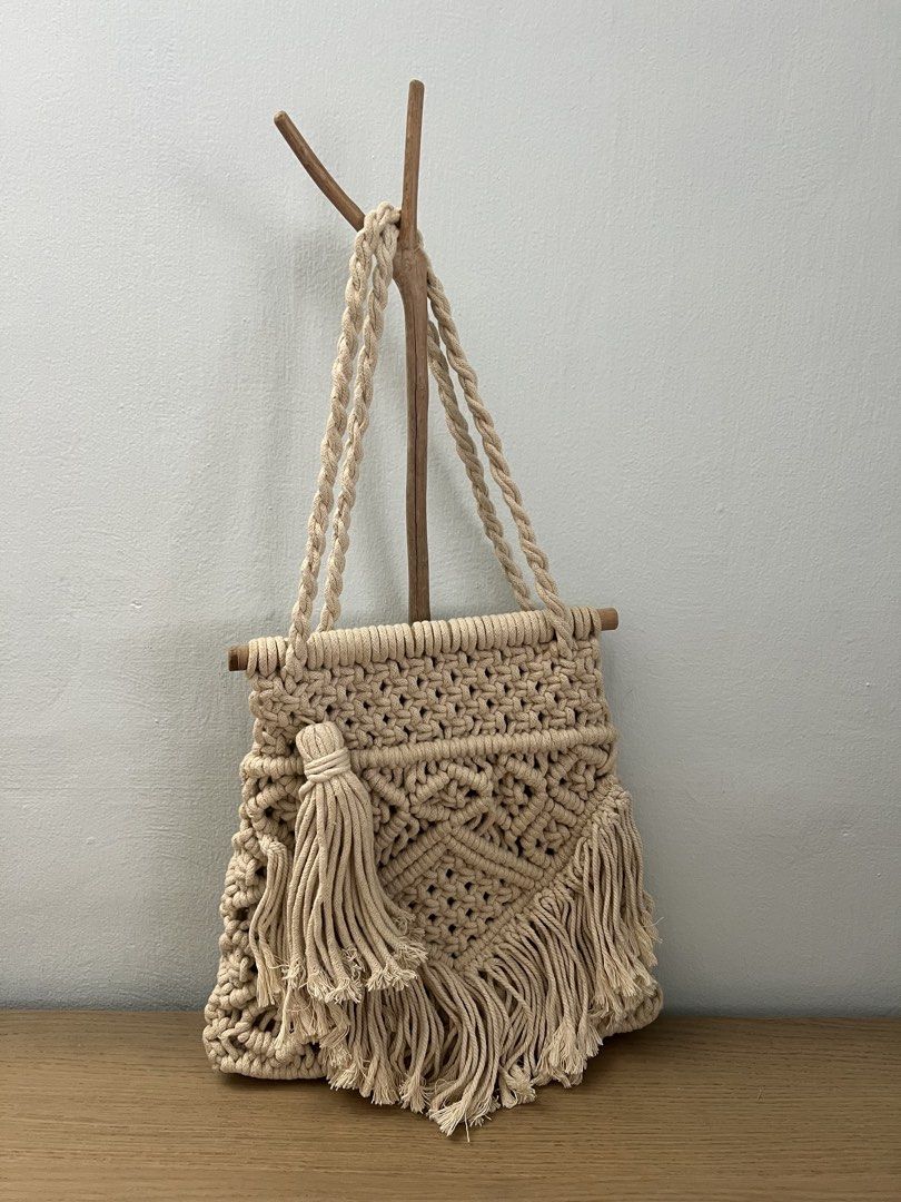 Zara Basic Macrame Handbag (Category: Shoulder Bags) located in Singapore. Submitted by ikml2015 (Listing ID 1437816115, Image 1). Description: Beautiful Zara Basic macrame handbag. Features a unique woven design with a tassel detail. The bag has sturdy handles and a wooden bar at the top. Perfect for adding a bohemian touch to any outfit..