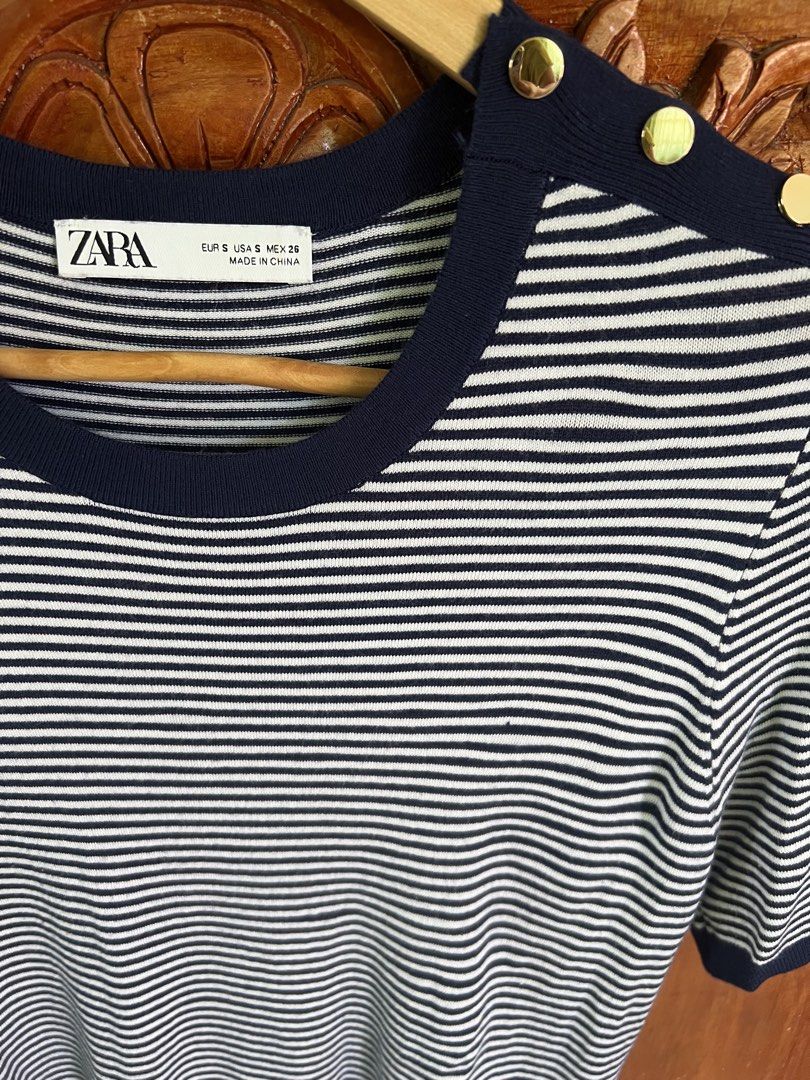 Zara Striped Top with Gold Buttons (Category: Blouses) located in San Fernando. Submitted by prettyfinds2021 (Listing ID 1437769742, Image 2). Description: - Zara striped top - Navy blue trim and gold button shoulder details - Round neckline, short sleeves - Size S - Made in China.
