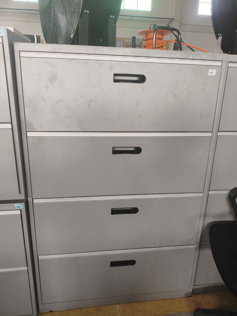 4-Drawer Metal Filing Cabinet (Category: Office Furniture & Fixtures) located in Manila. Submitted by hmrgrace5. (Listing ID 1438003820, Image 2). Description: - 4-drawer metal filing cabinet - Light gray finish - Black drawer handles - Spacious drawers for document storage - Perfect for office or home use.