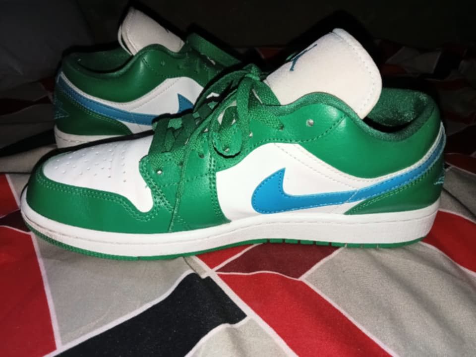 Air Jordan 1 Low Green White (Category: Sneakers) located in Magalang. Submitted by zeiansoria64090 (Listing ID 1437976028, Image 2). Description: - Air Jordan 1 Low sneakers - Color: Green and white - Blue swoosh - Blue Jumpman logo on the tongue - Air Jordan wings logo on the heel - Green laces - White sole.