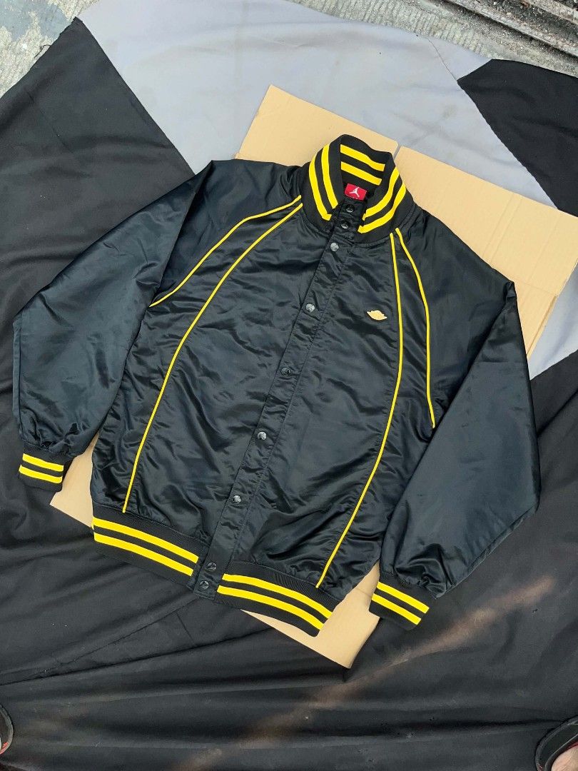 Air Jordan Black and Yellow Jacket (Category: Coats, Jackets and Outerwear) located in Manila. Submitted by jgabooo04 (Listing ID 1437951904, Image 1). Description: - Black jacket with yellow accents - Air Jordan logo on back and front - Button-up front - Striped collar and cuffs - Includes red Air Jordan tag - Size Medium .