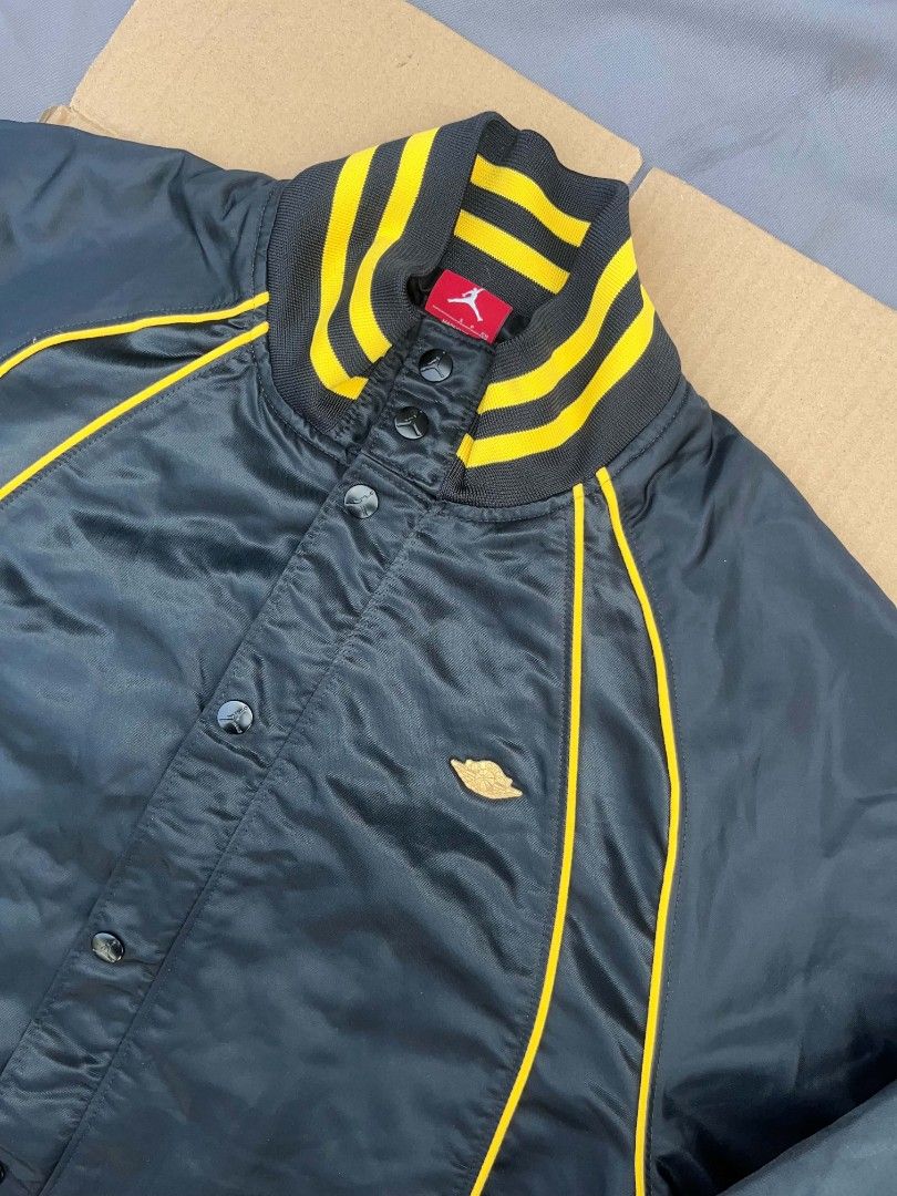 Air Jordan Black and Yellow Jacket (Category: Coats, Jackets and Outerwear) located in Manila. Submitted by jgabooo04 (Listing ID 1437951904, Image 3). Description: - Black jacket with yellow accents - Air Jordan logo on back and front - Button-up front - Striped collar and cuffs - Includes red Air Jordan tag - Size Medium .