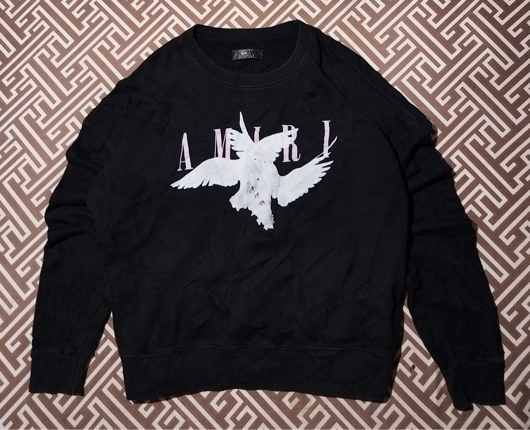 Amiri Dove Graphic Sweatshirt (Category: Coats, Jackets and Outerwear) located in Manila. Submitted by quann1 (Listing ID 1437971347, Image 1). Description: - Black Amiri sweatshirt - Dove graphic on front - Crew neck - Long sleeves - Ribbed cuffs - Medium weight fabric.