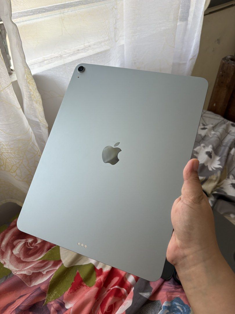 Apple iPad Air 13-inch (M3) (Category: iPad) located in Iloilo. Submitted by angelenepe01084 (Listing ID 1437939782, Image 2). Description: IPad Air 13-inch (M3) with 128GB storage. The device is blue. Includes a case. The screen displays the time and date. The iPad is running iPadOS version 26.4.1. With tempered glass installed and free 2 cases. Complete set box. No issue. Rfs: upgrade storage.