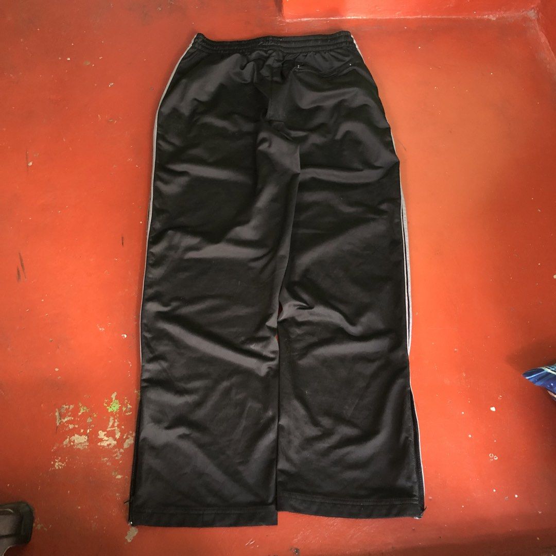 Athletic Works Men's Track Pants - Black (Category: Joggers) located in Manila. Submitted by dopethrift.cat (Listing ID 1438088200, Image 2). Description: Dimension: Inches Length: 40" Thigh: 14" Hem: 10" - Athletic Works track pants for men - Size: Large (36-38) - Features: - Drawstring waist - Side pockets - Zippered back pocket - White stripes on sides - Material: 100% polyester.